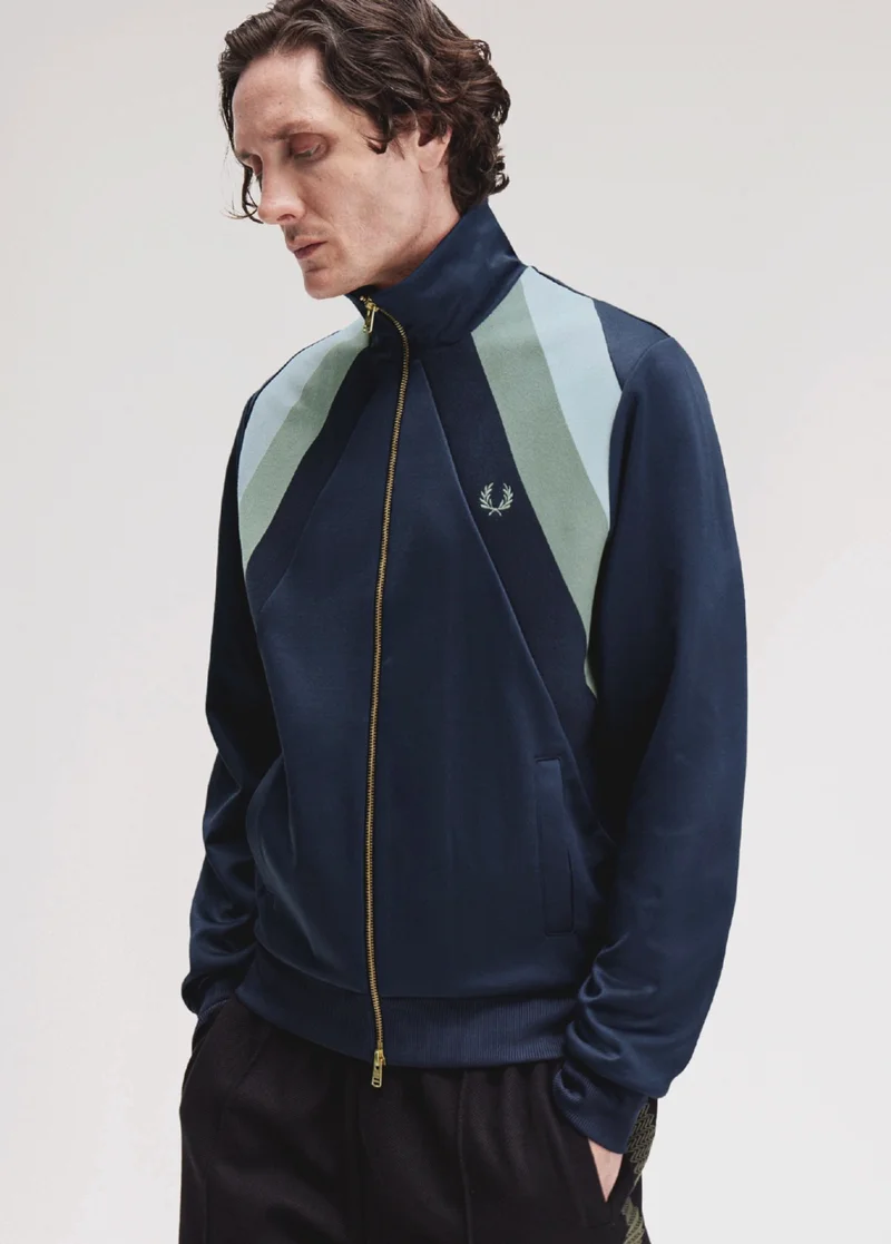Male model wearing a Striped Panel Track Jacket in Dark Airforce