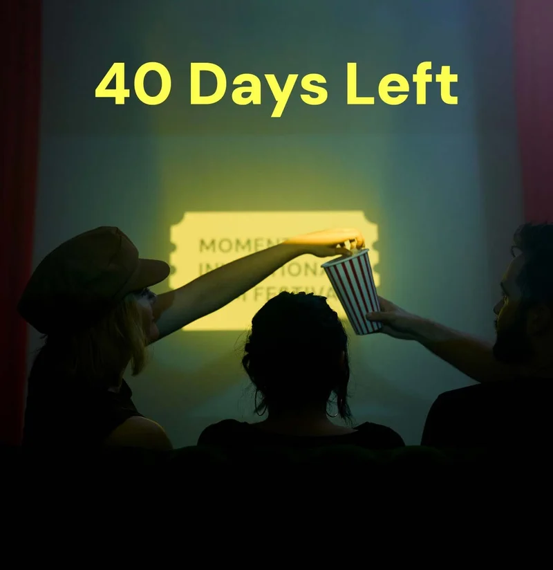 40 Days Left to Create Your Mobile Film - Image of 3 people sitting in a theater sharing some popcorn