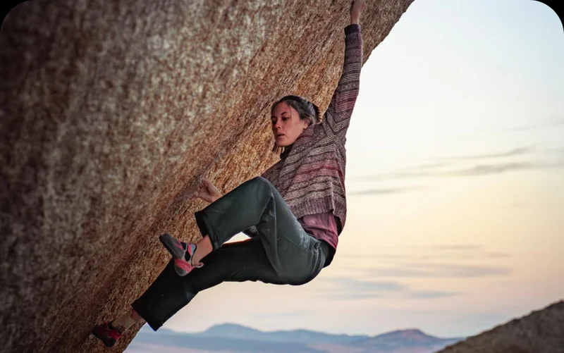 A person climbing on a rock.