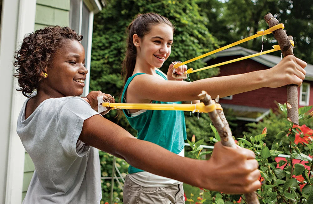 Kids hurling slingshots