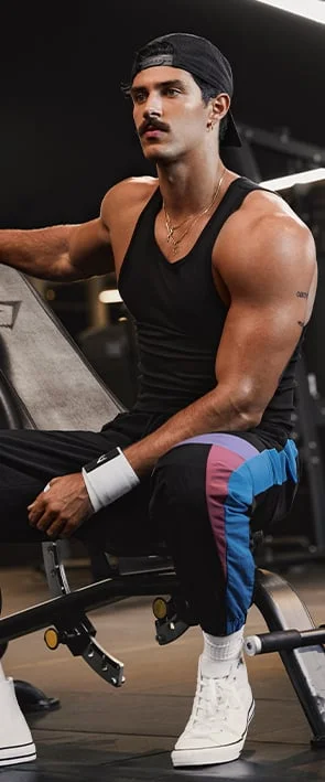 Steve Kelly wearing the Black Ribbed Tank and Retro Track Pants