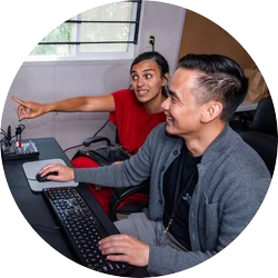 A fellow works with an advisor on their film during the Documentary Edit and Story Lab.