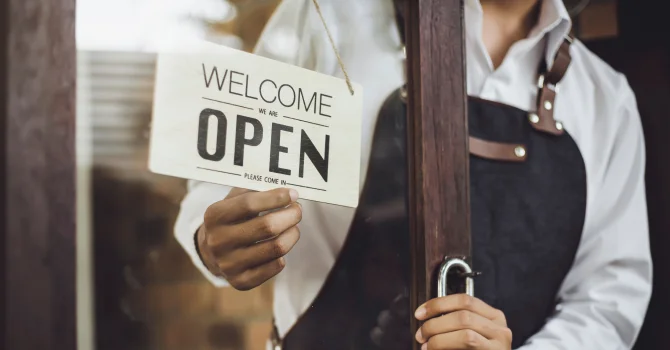 Business owner turning around an open sign