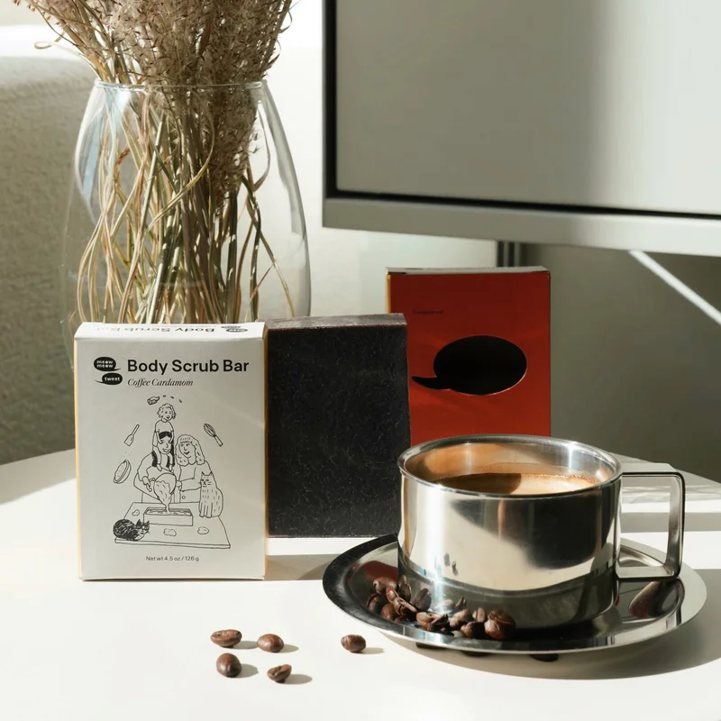 A bar of soap sits on a small table with a cup of coffee