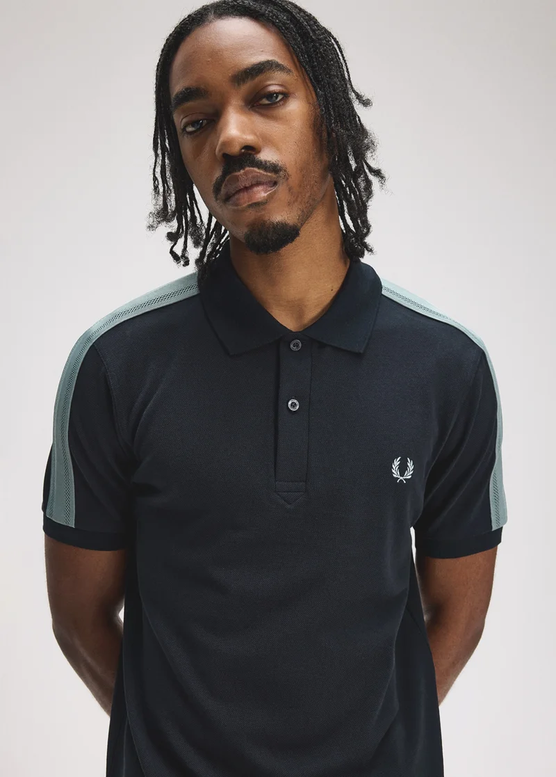 Male model wearing a Fred Perry Mesh Taped Polo Shirt in Navy