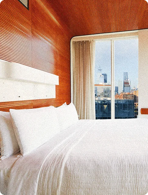 Image Description: Hotel room overlooking the New York City skyline