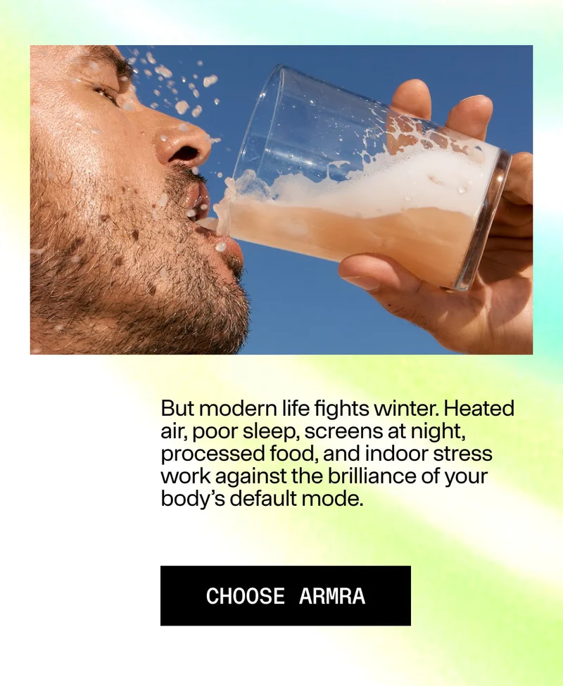 Person drinking a light-colored wellness beverage outdoors, representing modern lifestyle habits supported by ARMRA.