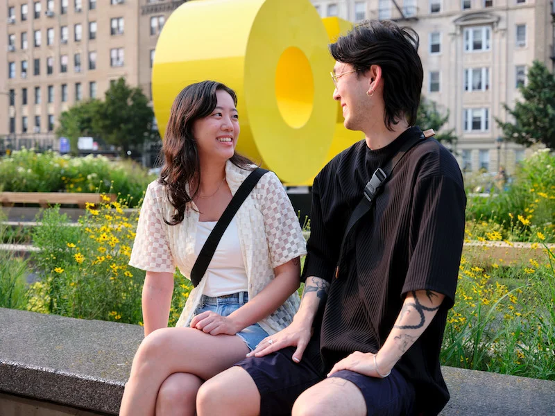 Two people sitting outside of the Brooklyn Museum