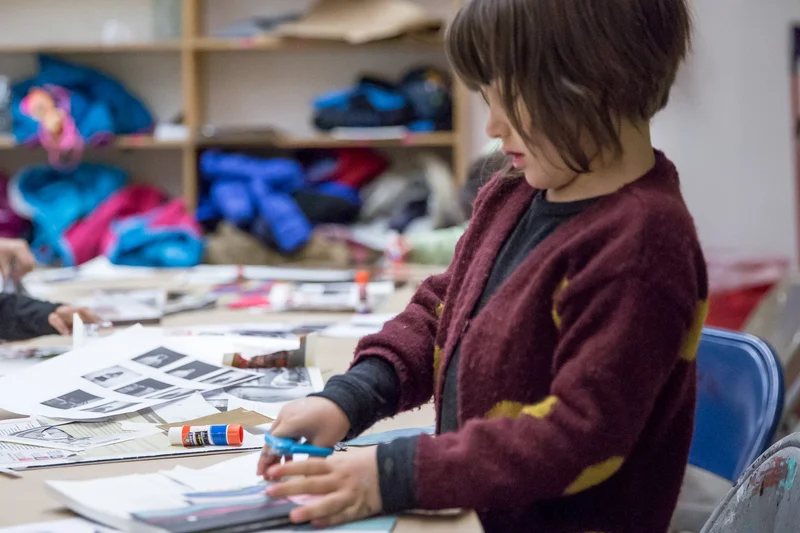 A child using scissors to create an art project