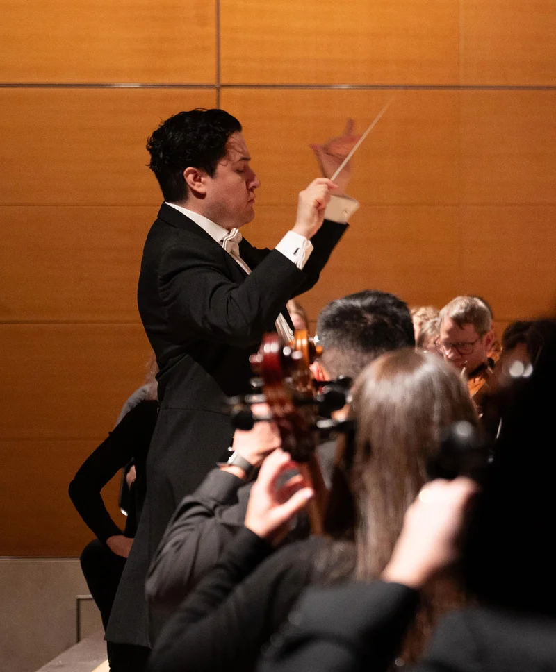 A conductor leading an orchestra