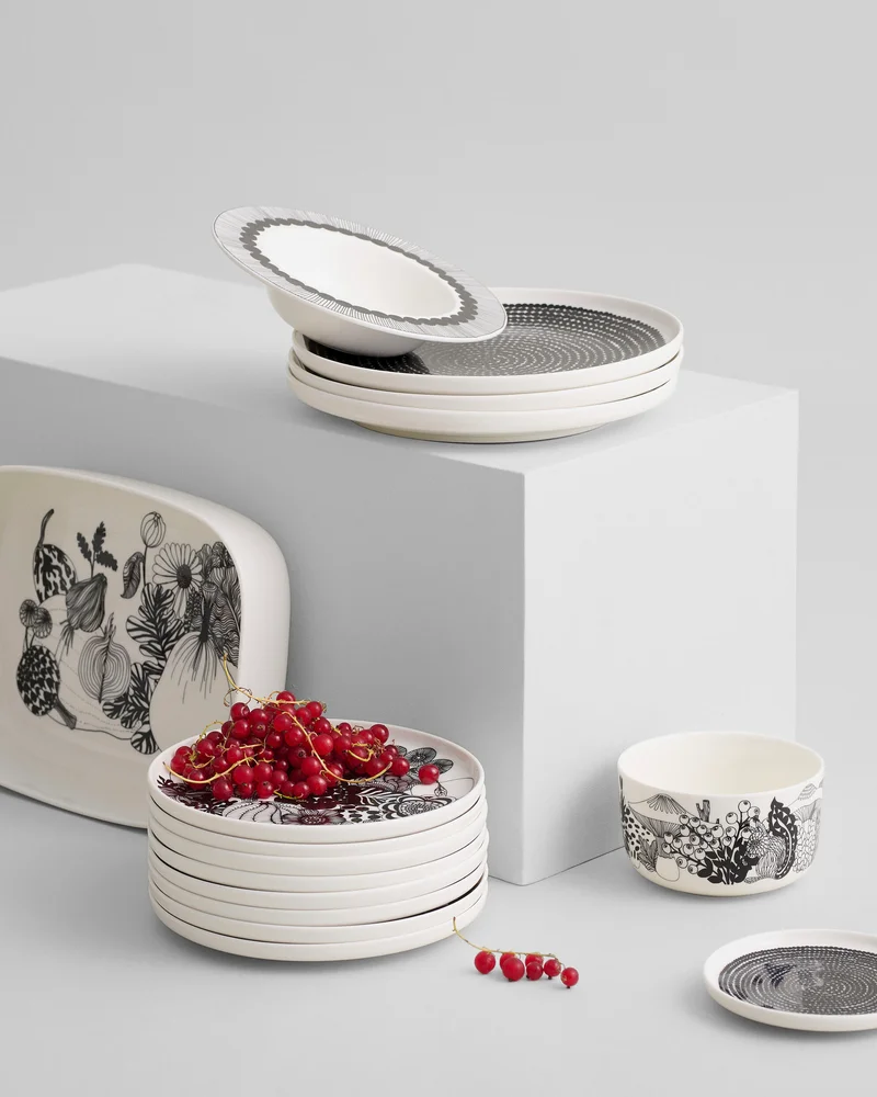 stack of plates and bowls with fruit