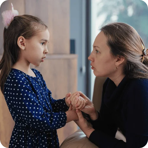 a girl talking to her mom, who used a phrase that secretly undermines kids confidence a girl talking to her mom, who used a phrase that secretly undermines kids confidence