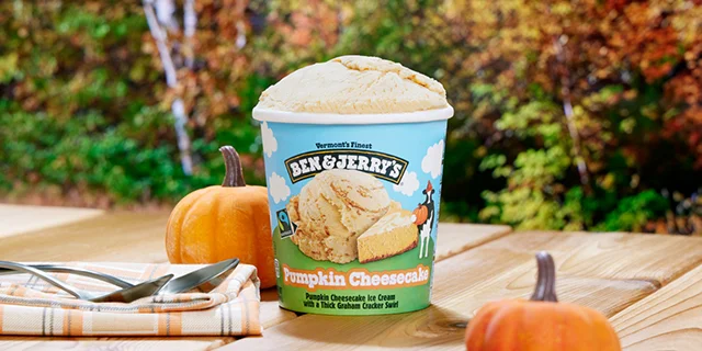 Ben & Jerry's Pumpkin Cheesecake ice cream next to a small pumpkin