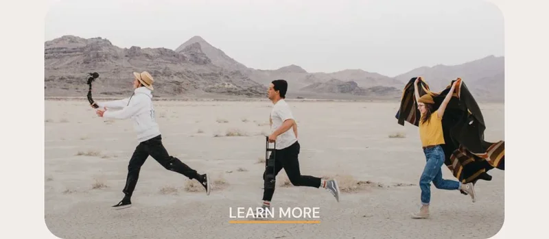 Image of 3 creators running through the dessert with the caption "Read More"