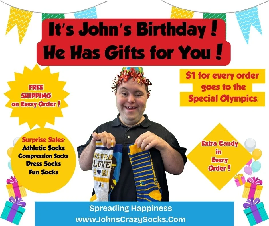 John holding socks and wearing a birthday hat