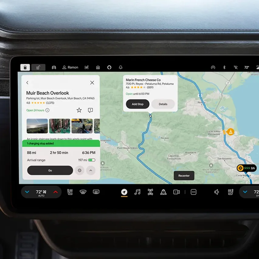 A car's infotainment screen displaying a navigation app. On the left, details for Muir Beach Overlook are shown, including photos and estimated travel time. On the right, a map shows a route with Narin French Cheese Co. as a destination.