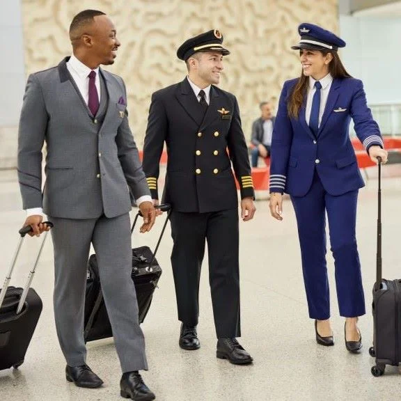 Delta and LATAM employees walking in an airport.