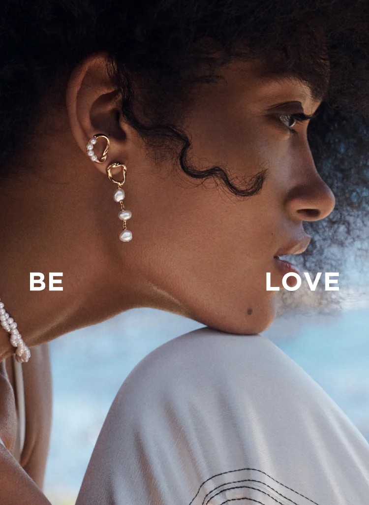 Model wears stacked PANDORA ESSENCE earrings