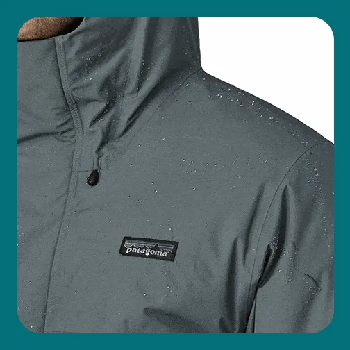 Stormshadow Parka detail image of the two-way, center-front zipper with an external storm flap and internal zippered chest pocket.
