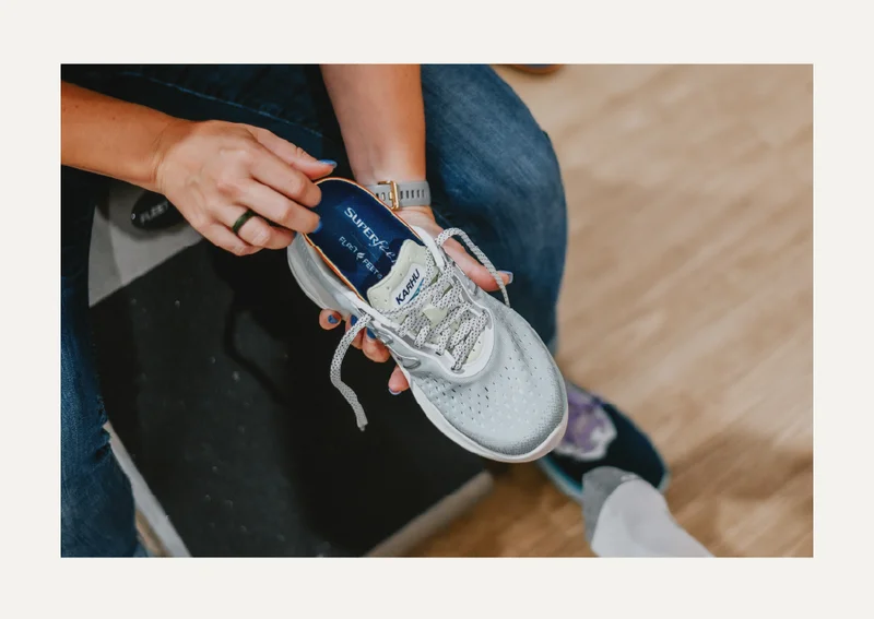 Outfitter putting an insole into a shoe