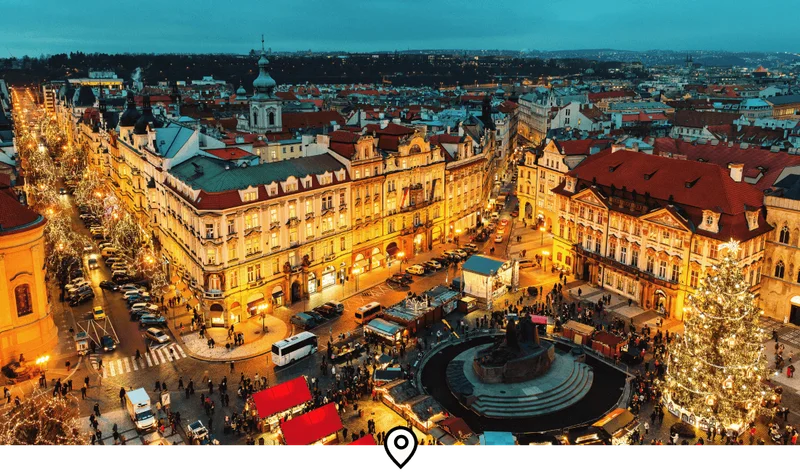 Image Description: An aerial view of festive markets and light-ups around Prague’s Old Town Square