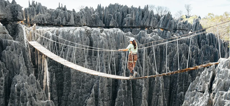 Tsingy de Bemaraha National Park, Woman crossing the wooden bridge