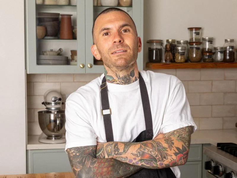 Image may contain: Adult, Person, Chef, Skin, Tattoo, Cooktop, Indoors, and Kitchen