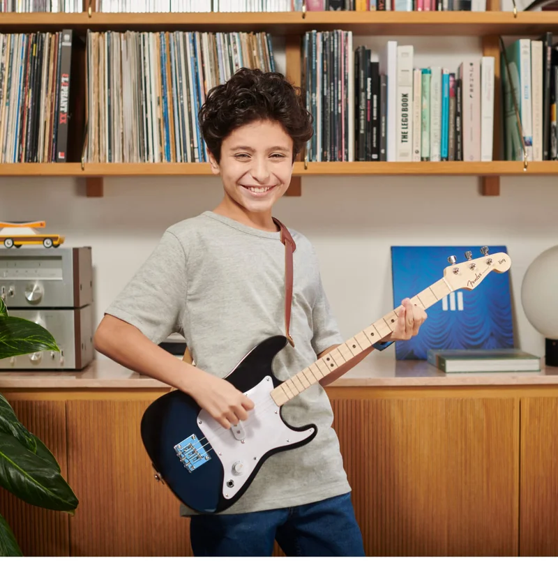 kid playing Fender x loog guitar
