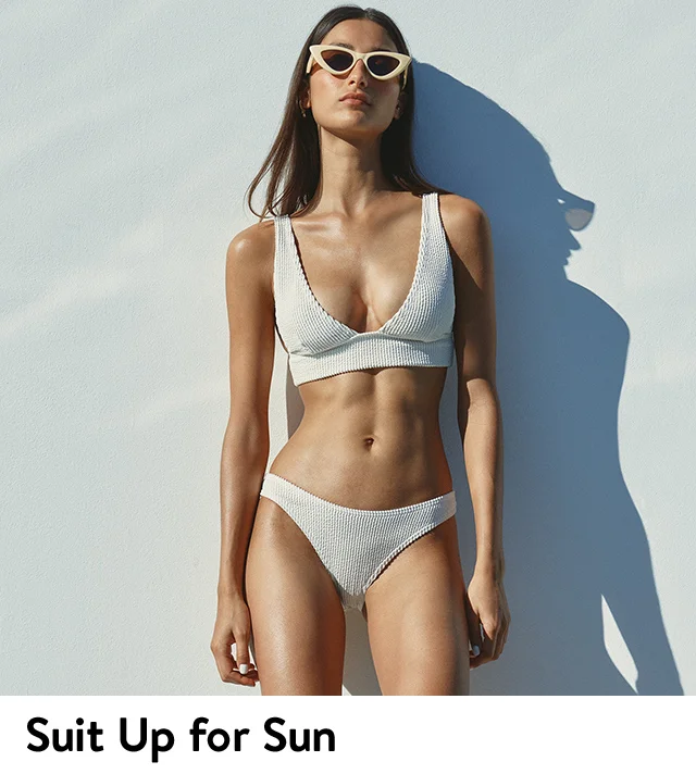 A woman wearing a bikini and cat-eye sunglasses.