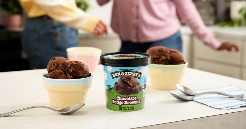 Kitchen setting, pint of Ben & Jerry's Chocolate Fudge Brownie ice cream on the counter with two bowls.
