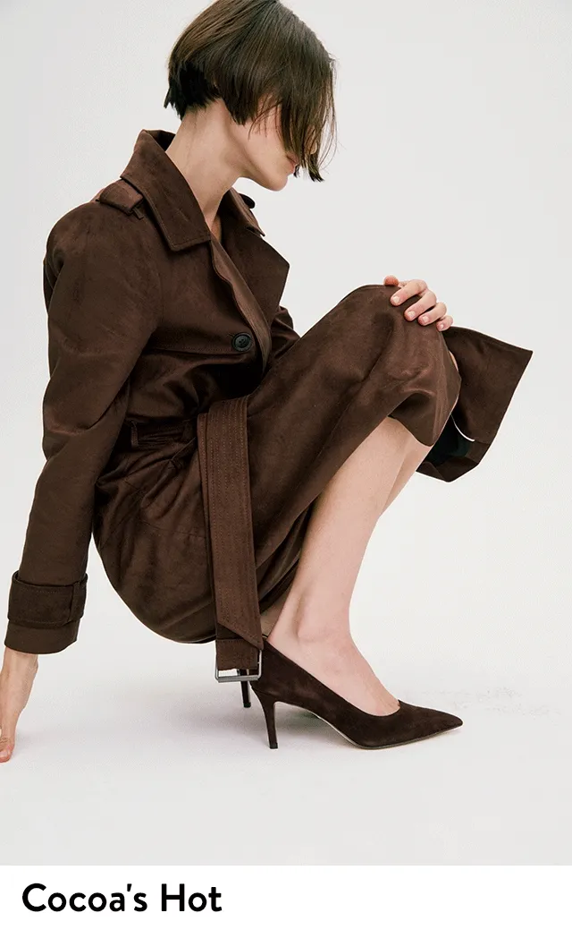 A woman wearing dark brown pumps.