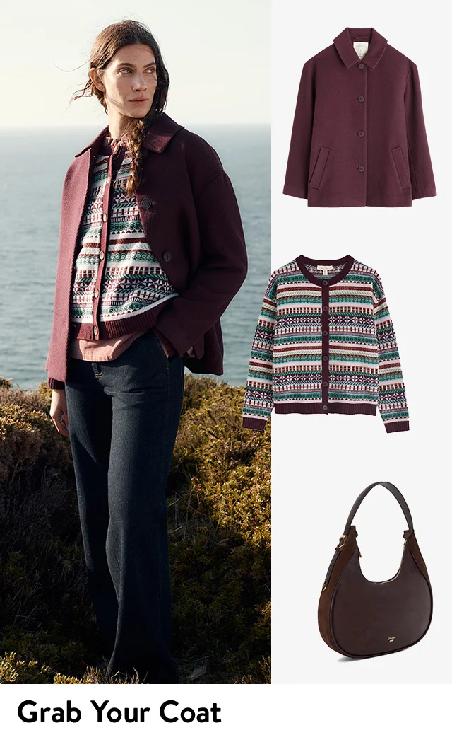 A woman wearing jacket over a patterned cardigan with jeans; the jacket, cardigan, jeans and a handbag.