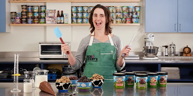 Flavor Guru Sarah Fidler in the Ben & Jerry's test kitchen surrounded by pints.
