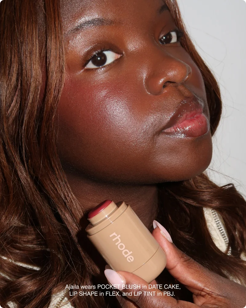 Ajaila wears POCKET BLUSH in DATE CAKE, LIP SHAPE in FLEX, and LIP TINT in PBJ