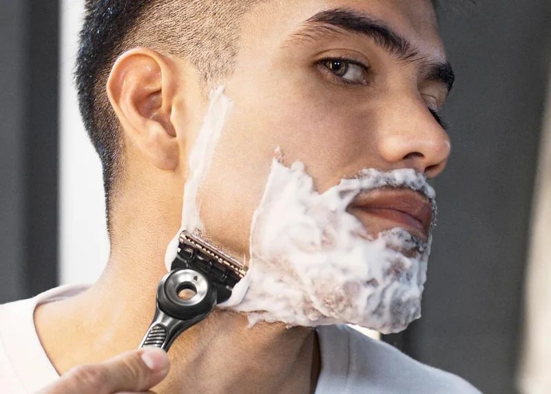 Man shaving his face with GilletteLabs with Exfoliating Razor Bar