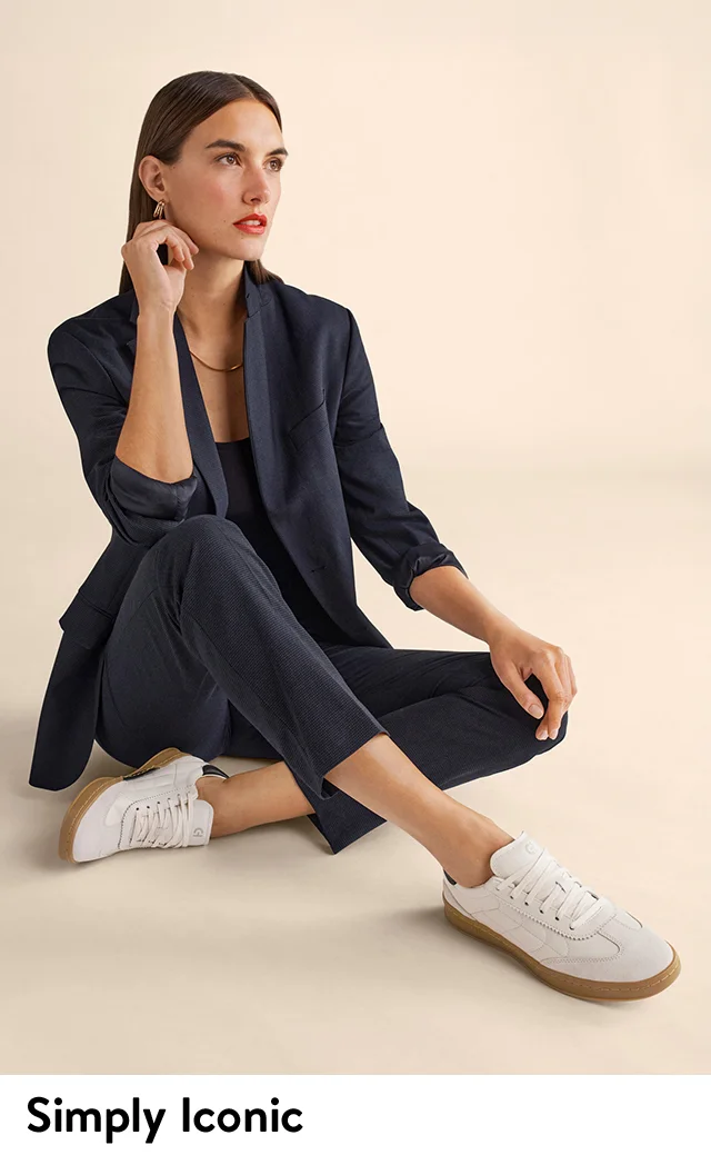A woman wearing white sneakers.