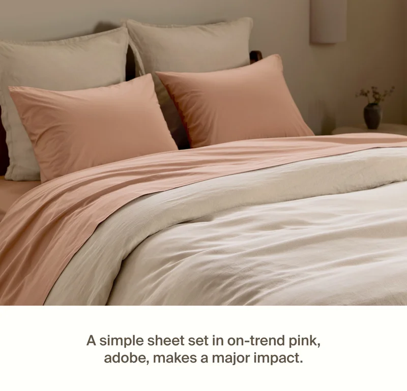 Bed styled with on-trend pink, Adobe.