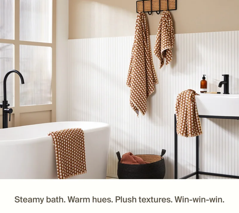 Earthy geometric towels styled in modern bathroom.