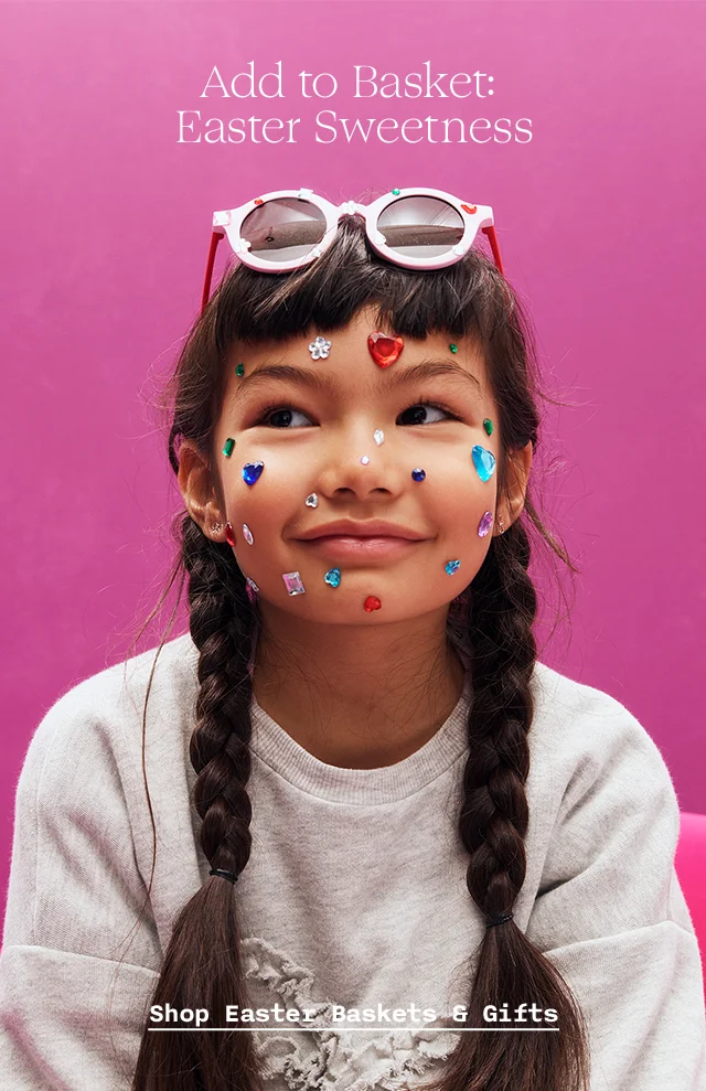 A girl with gem stickers on her face and sunglasses.