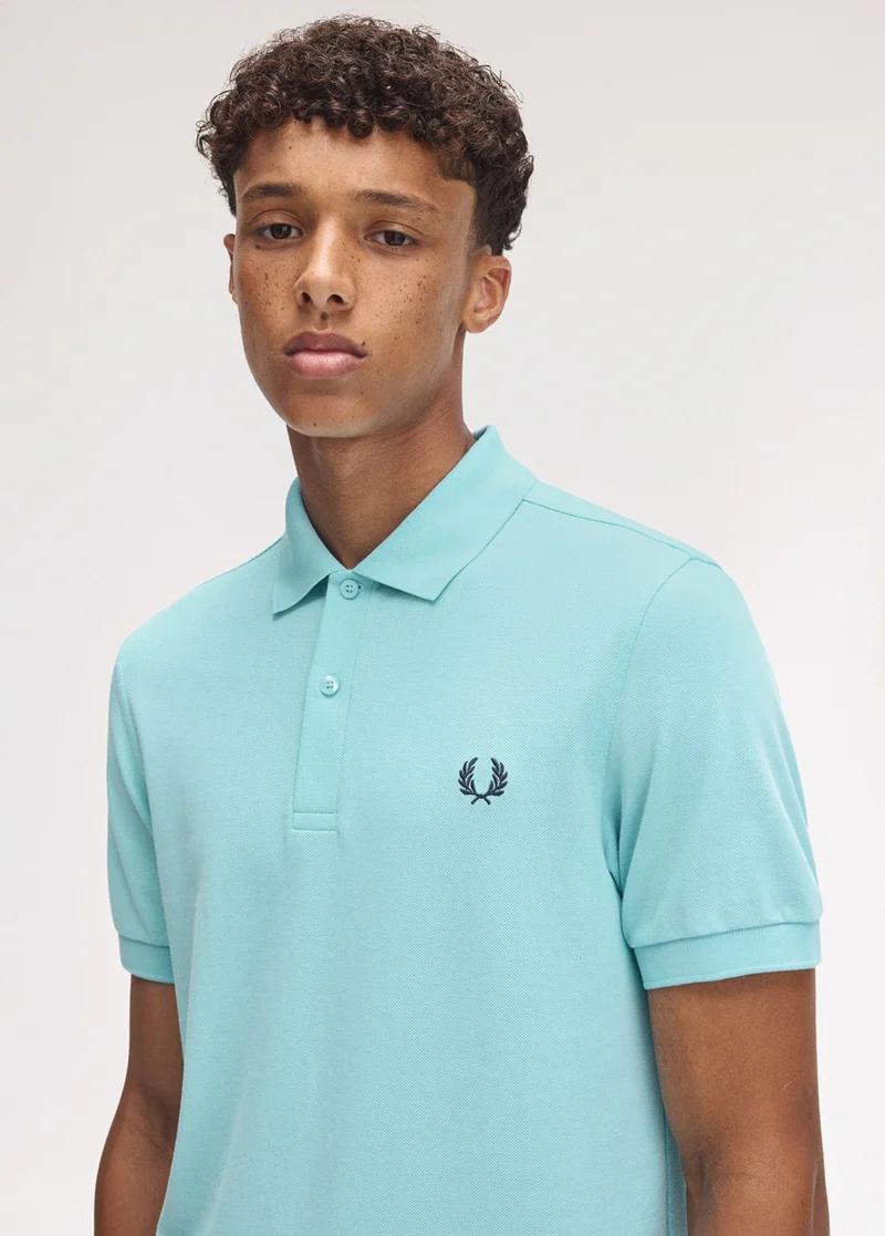 Male model wearing a Mint Blue M6000 Fred Perry Shirt