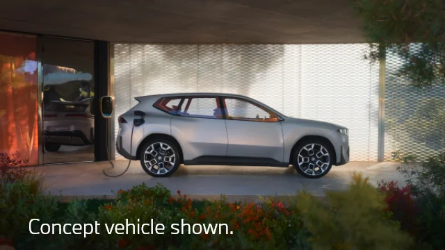 Neue Klasse X parked and plugged in for charging. Concept vehicle shown.