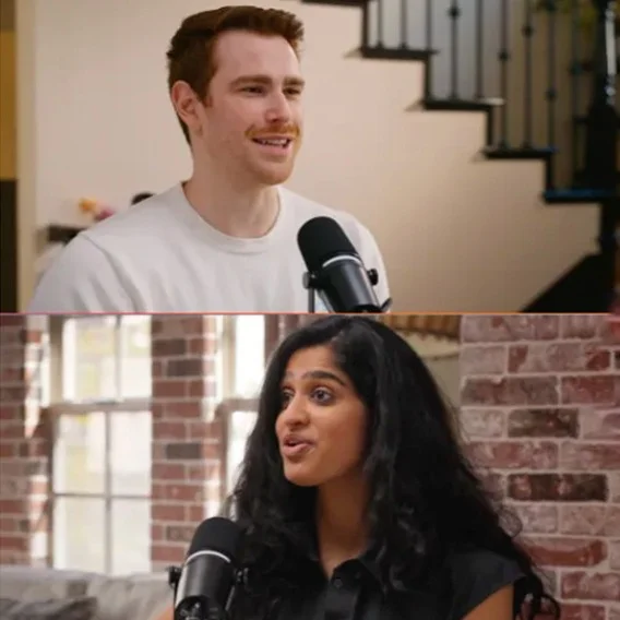 A picture of two people having a conversation using microphones