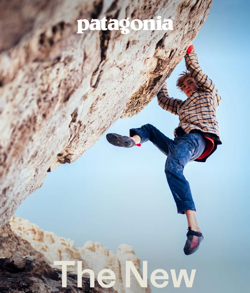 Patagonia. A person climbs a rock overhang.