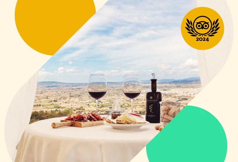 Image Description: Two wine glasses and a charcuterie board on a table at Restaurant Puig de Santa Magdalena in Majorca, Spain, with a Travelers’ Choice Awards badge overlaid on the image