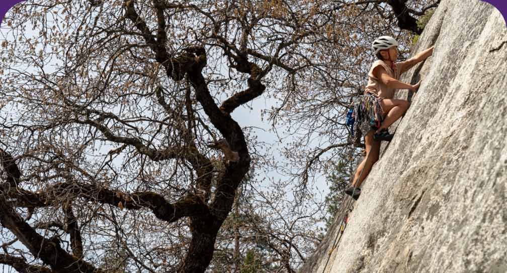 A person climbing on a rock.