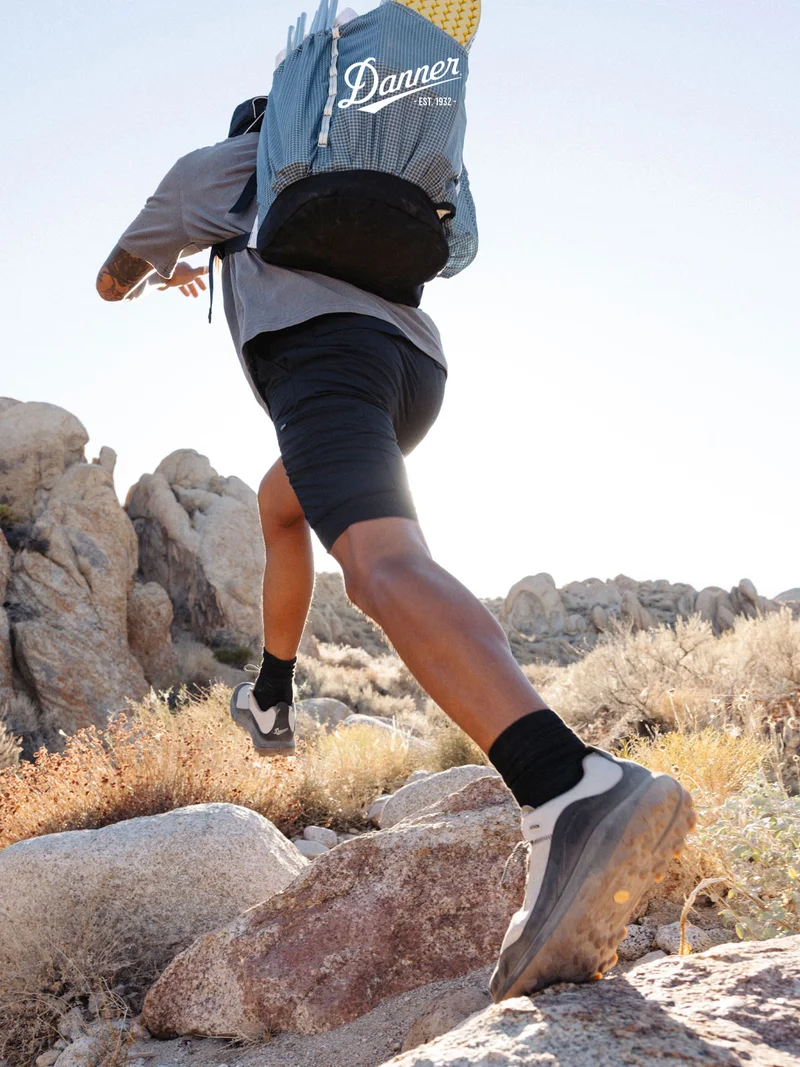 A person strides up a rocky desert path wearing the new N45 hiker.
