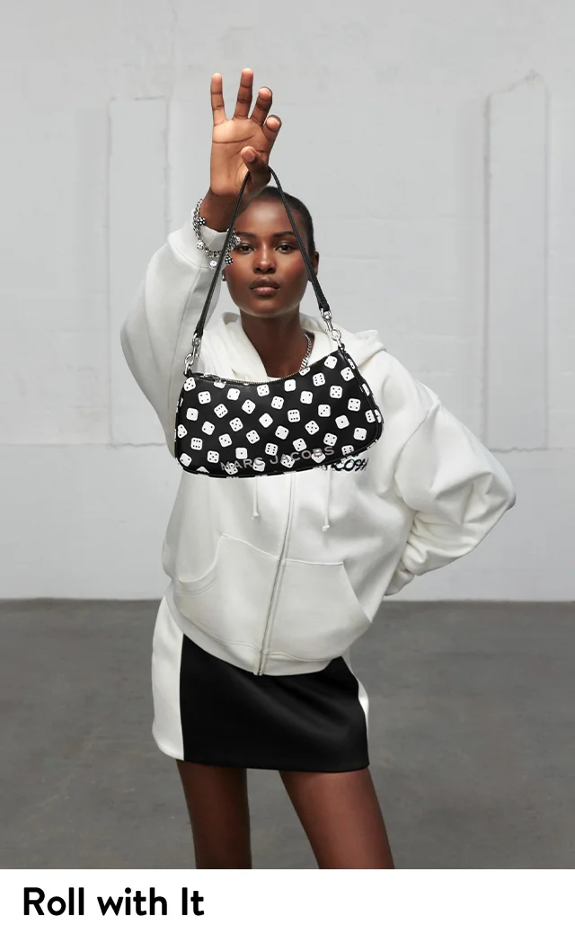 A woman holding a dice-print bag.