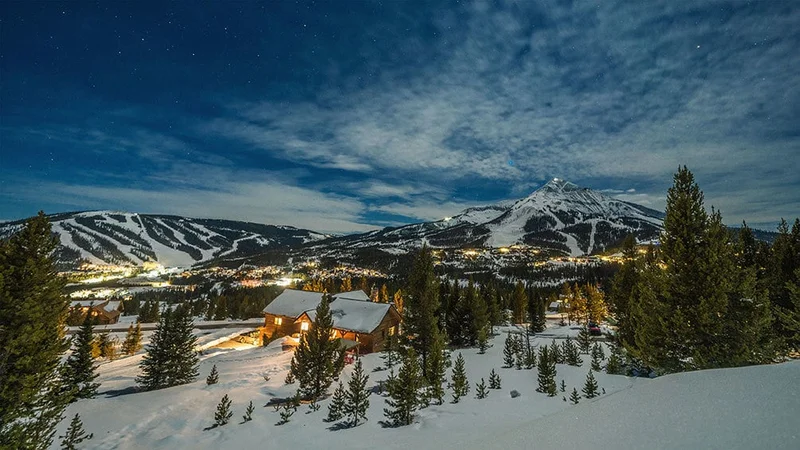 Image description: Cabin at dusk in Big Sky, Montana, in the winter