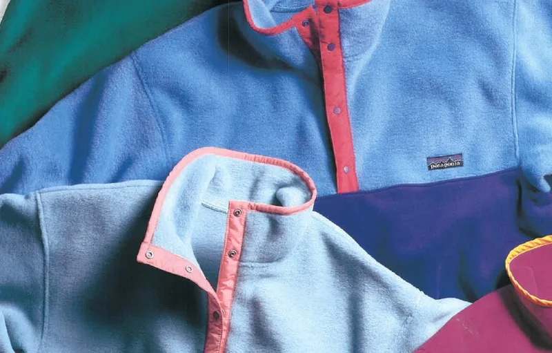 A laydown photo of kids’ fleece jackets.