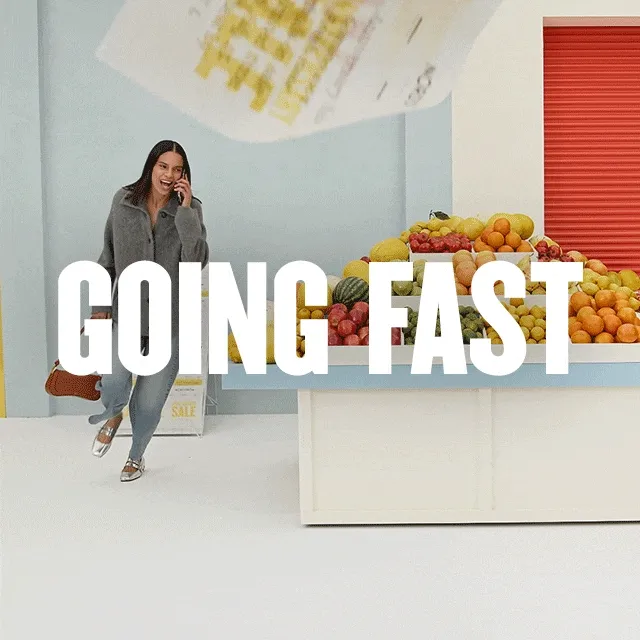 Anniversary Sale is going fast: ends Sunday! A woman runs through a supermarket.